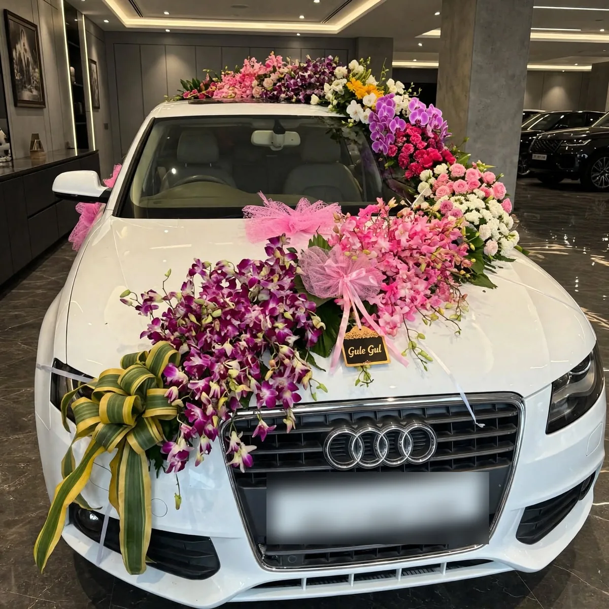 Purple Orchid Car Decor: Purple orchids and pink flowers on the bonnet and roof of a white car, with pink tulle and a ribbon bow, GuleGul Flowers Lahore