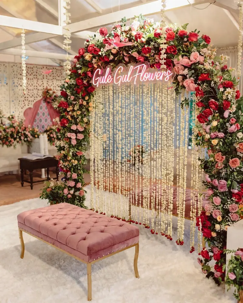 Nikkah Flower Arch with Motia Curtain: Nikkah decor with a red and pink rose arch, motia flower curtain and pink velvet bench, GuleGul Flowers Lahore